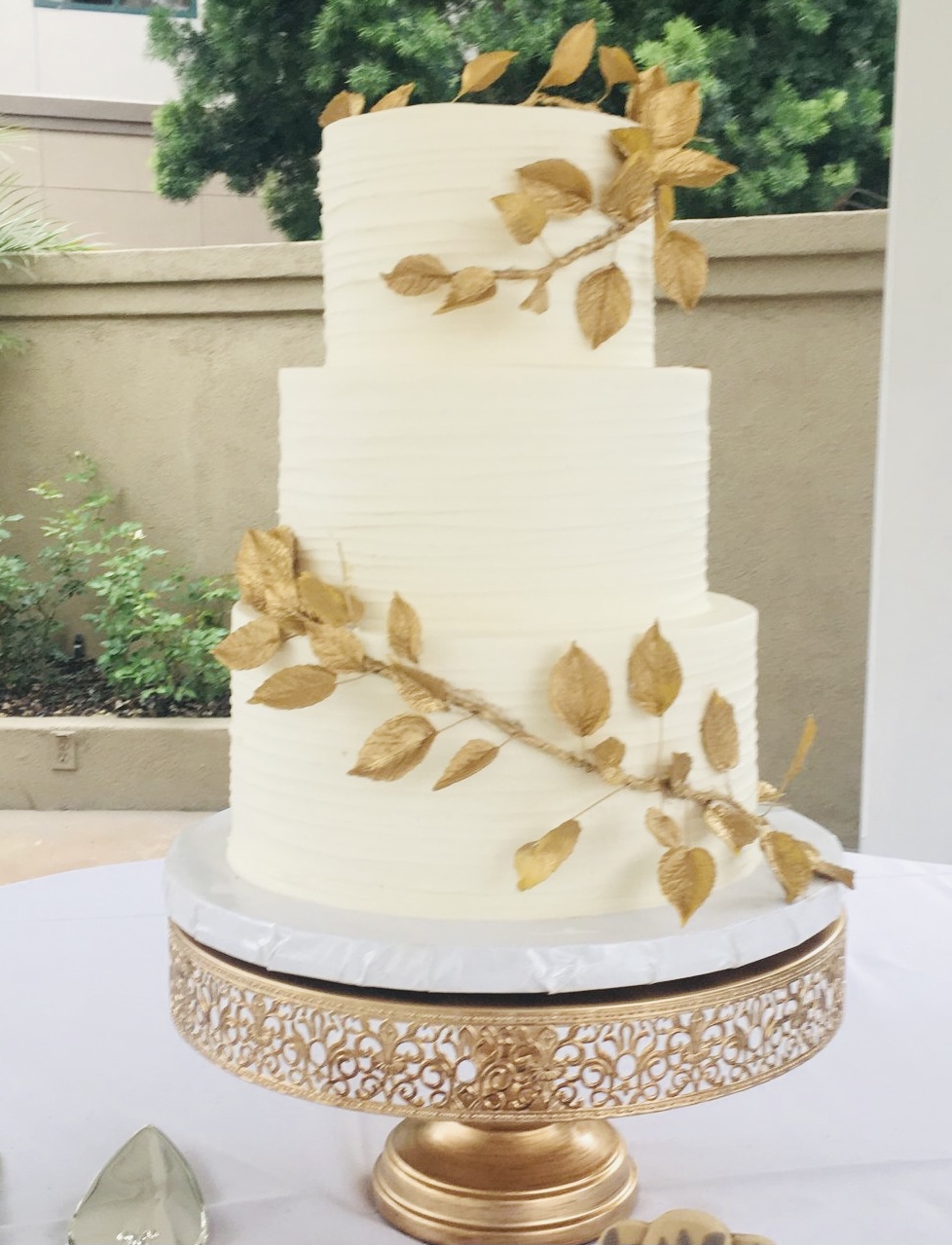 grecian-style golf leaf cascade wedding cake 